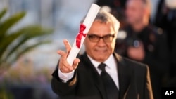 Iranian filmmaker Mohammad Rasoulof poses for photographers after winning a special jury prize at the Cannes festival on May 25.