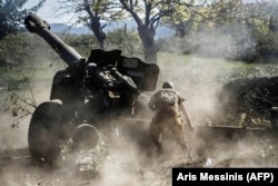 An ethnic Armenian fighter fires heavy artillery during the intense 2020 conflict with Azerbaijan over Nagorno-Karabakh.