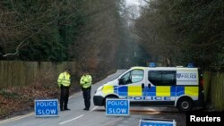 A police cordon blocks the road leading to Russian oligarch Boris Berezovsky's house, after he was found dead on March 23 at his home near Ascot in Berkshire.
