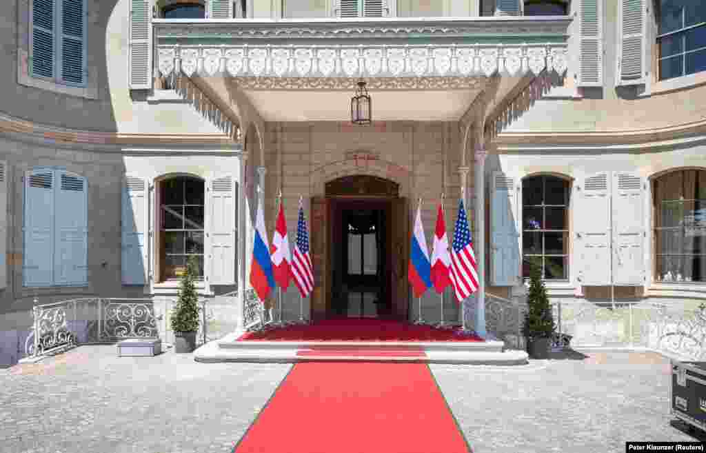 U.S., Russian, and Swiss flags at the entrance to Villa La Grange, on the banks of Lake Geneva. 