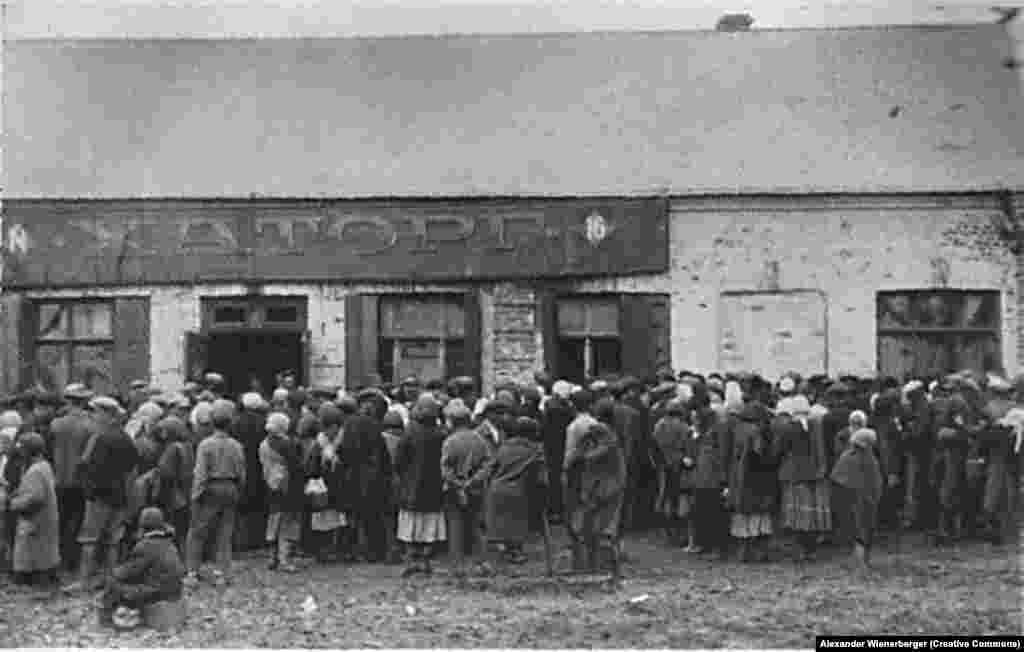 The empty "Chartorg" (Charower Trade Cooperative) food distribution site is besieged by a devastated population in Kharkiv..